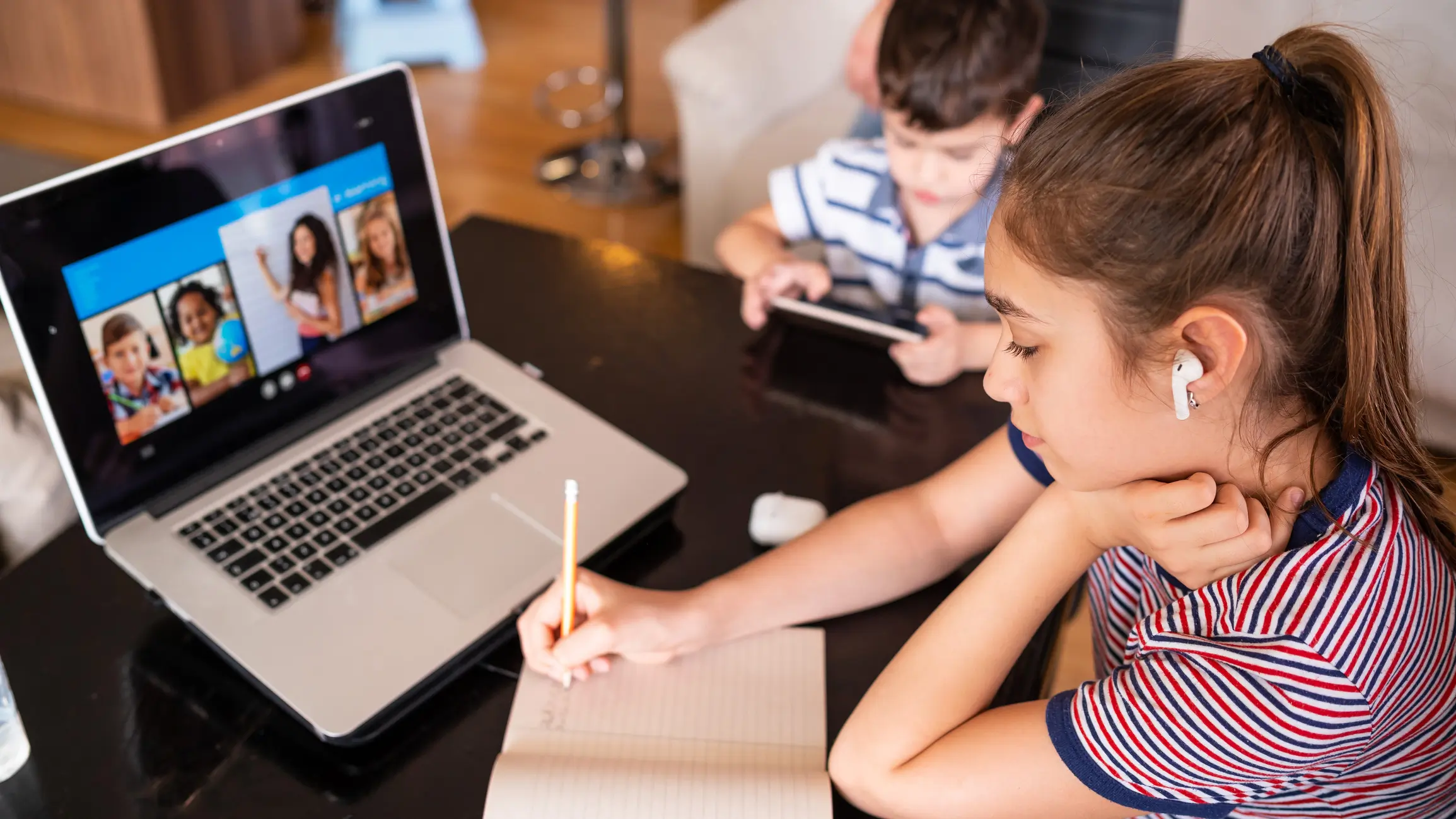 Teenage girl studying with video online lesson at home family in isolation