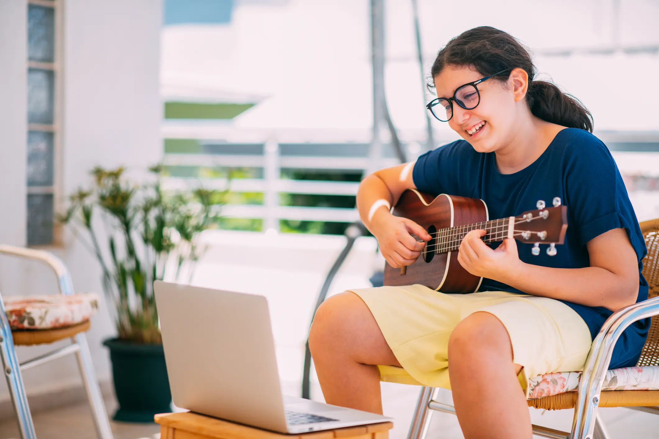 Little Girl is Taking Guitar Lesson Online